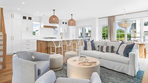 A modern living room with a sofa set, ottomans, and a coffee table. - Stareway to Heaven in Fairfield (Fairfield)