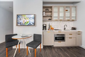A modern kitchen with a marble countertop, built-in oven, and a coffee station. - 17john: Queen Studio Apartment - Disability Access (New York)