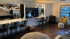 A modern kitchen with a large island, built-in appliances, and a flat-screen TV. - Great Place to Stay When Visiting - Pet Friendly (Rushville)