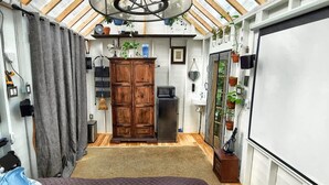 A compact kitchen with wooden cabinets, a refrigerator, and a small sink.