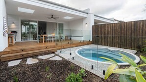 A modern house with a patio, a pool, and a wooden deck. - Rubus Pink Berry - by Linnaeus Collection (Berry)