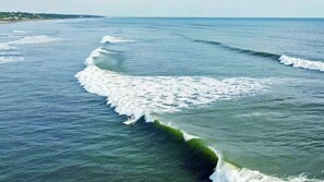 A coastal view with waves breaking on the shore.