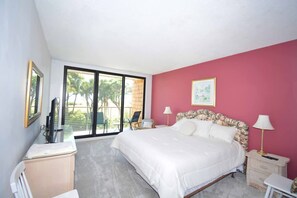 Un dormitorio con cama, mesitas de noche, escritorio y una silla.