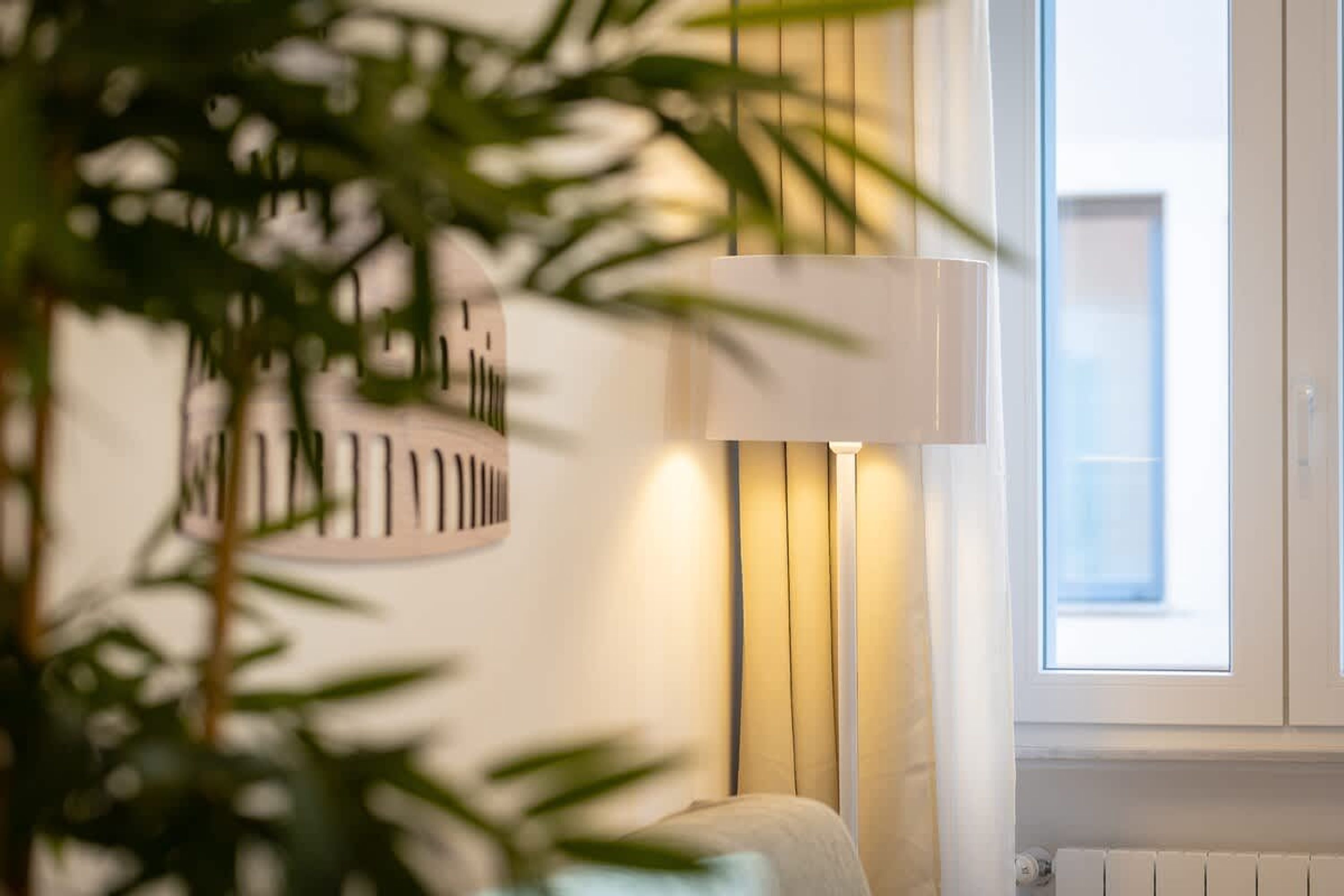 A room with a window, a lamp, and a radiator.