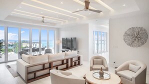 A modern living room with a sofa set, armchairs, and a coffee table. - Oceanfront Penthouse and Patio at ONE Cable Beach (Nassau)