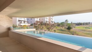 A modern hotel room with a large balcony overlooking a swimming pool and a golf course. - Encanto 822 by Owner Luxury Sunset Getaway Punta Mita (Punta de Mita)