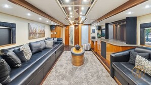 Un intérieur moderne avec un ensemble de canapés, une table basse ronde et un coin bar.