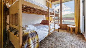 A bunk bed room with a view of the outdoors. - Belle Vue Apartment 423 (Riddes)