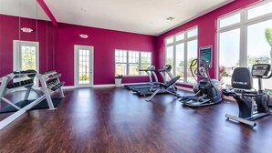 A gym with treadmills, elliptical machines, and weight machines. - 4Bd Minions Themed Home Near Disney Sleeps 10 (Kissimmee)