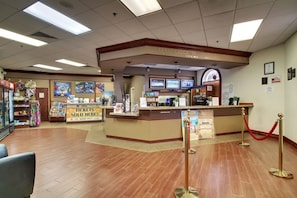 A hotel lobby with a reception desk, a ticket counter, and a check-in area. - 4Br Resort Home With Pool and Lazy River Sleeps 8 (Davenport)