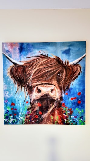 A painting of a yak with horns and a beard, surrounded by colorful flowers. - Haycombe Farm Cottage (Camelford)