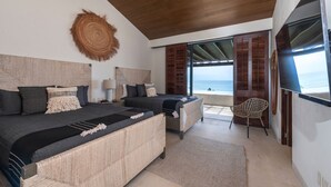 A bedroom with a large bed, a smaller bed, a chair, and a view of the sea. - PH Vista Ballena in Punta Mita (Punta de Mita)