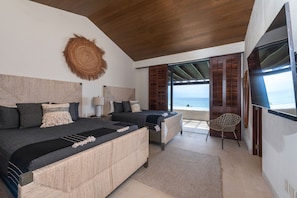 A bedroom with a large bed, a smaller bed, a chair, and a view of the sea. - PH Vista Ballena in Punta Mita (Punta de Mita)