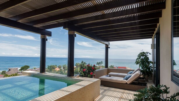 A pool area with a view of the ocean, a covered seating area with cushions, and a potted plant. - PH Vista Ballena in Punta Mita (Punta de Mita)