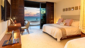 A bedroom with a bed, a desk, a chair, and a view of the ocean. - Condo Haramara in Punta Mita (Punta de Mita)