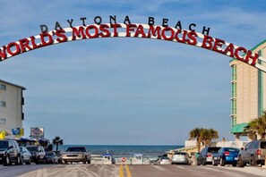 A road leading to Daytona Beach with a sign stating 'Daytona Beach World's Most Famous Beach.' - Oceanfront Condo Balcony Daytona Beach (Daytona Beach)