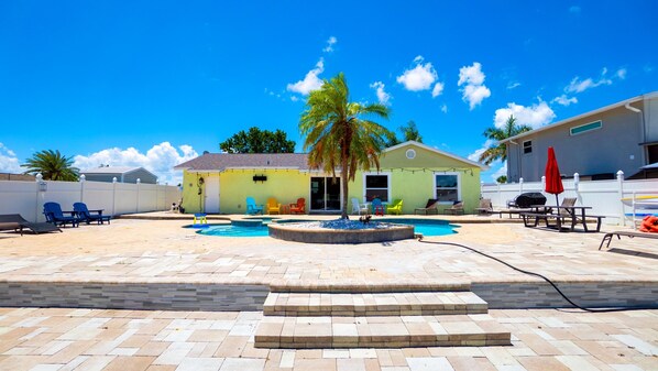 A backyard with a swimming pool, lounge chairs, and a small building. - Fun Pool Relax16miles Bushgarden (Tampa)
