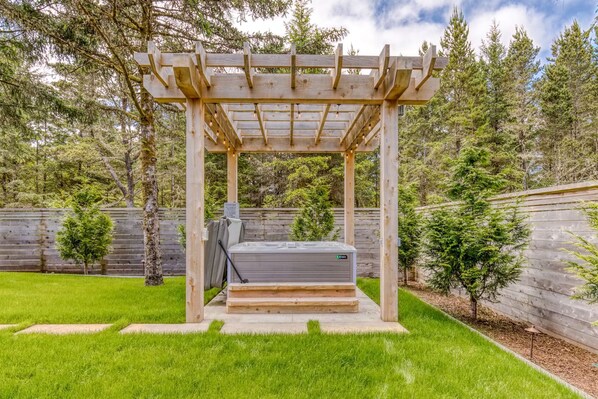 A wooden pergola structure with a built-in hot tub in a backyard. - Boutique Cabin Design Luxury Hot Tub Path to Beach (Long Beach)