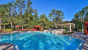 A swimming pool with lounge chairs and a gazebo, surrounded by trees. - Come and Stay at the Best of Championsgate! (Davenport)