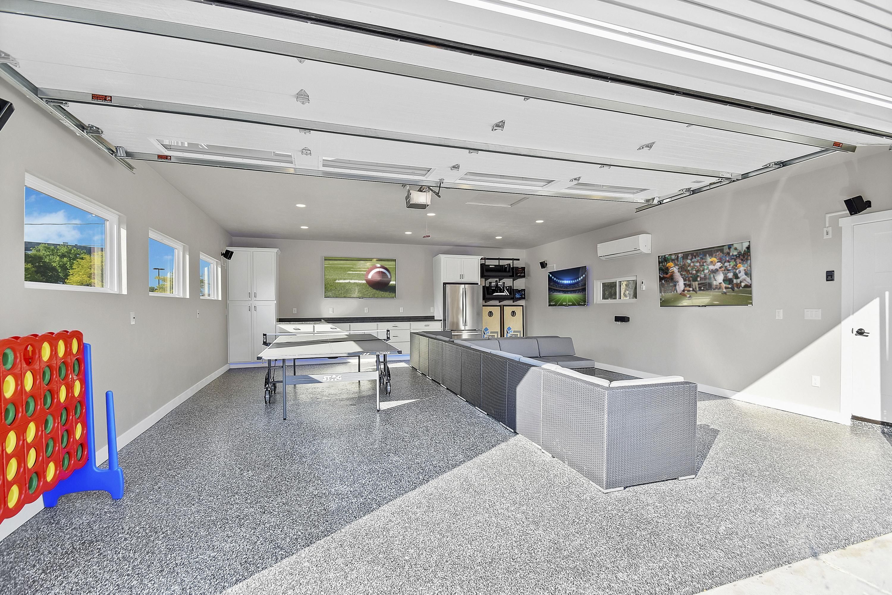 A modern kitchen with a large island, built-in appliances, and a view of the outdoors.