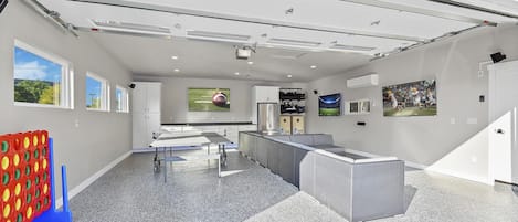 A modern kitchen with a large island, built-in appliances, and a view of the outdoors.