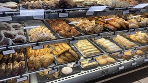 Mostrador de pastelería con diferentes productos horneados como pasteles, galletas y tartas.
