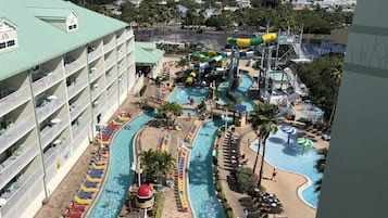 A hotel with multiple swimming pools, a water park, and a view of the ocean.