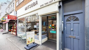 A storefront with a sign reading "MITSUBA" and a blue door with the number 92. - 2 Bedroom Charming Magnificent Flat (London)