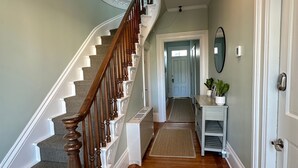 A wooden staircase with a white railing leading to a landing. - Entire Charming Victorian Home Downtown Newport (Newport)