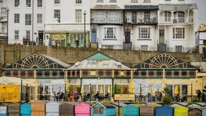 A row of colorful beach huts in front of a white building with a sign for 'Sands & Garden Bars'. - Luxury Ocean North Foreland Golf View By Adliv (Broadstairs)