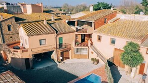 A residential area with a swimming pool, a car, and a building with a balcony. - Casa Rural en el Centro Hist Rico de Gualta (Gualta)