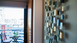 A room with a view of a balcony and a wall-mounted decorative panel. - Victoria Diagonal Mar 2 Design Duplex Penthouse (Barcelona)