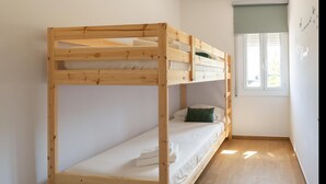 A bunk bed room with a window and a wall with text.