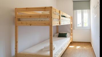 A bunk bed room with a window and a wall with text.