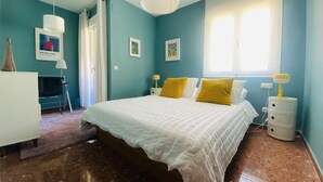 A bedroom with a bed, two bedside tables, a dresser, a window with curtains, and a door. - Nerja Sun Apartamento Jabega Torrecilla (Nerja)
