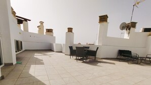 A rooftop terrace with tiled flooring, a table with chairs, and a sofa. - Apartamento Bronce A Centro Nerja Sun (Nerja)