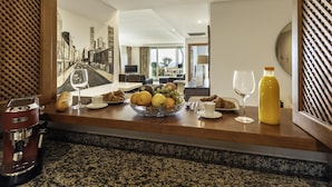 A breakfast setup with croissants, fruits, and a coffee machine. - Apartamento Afrodita (Estepona)