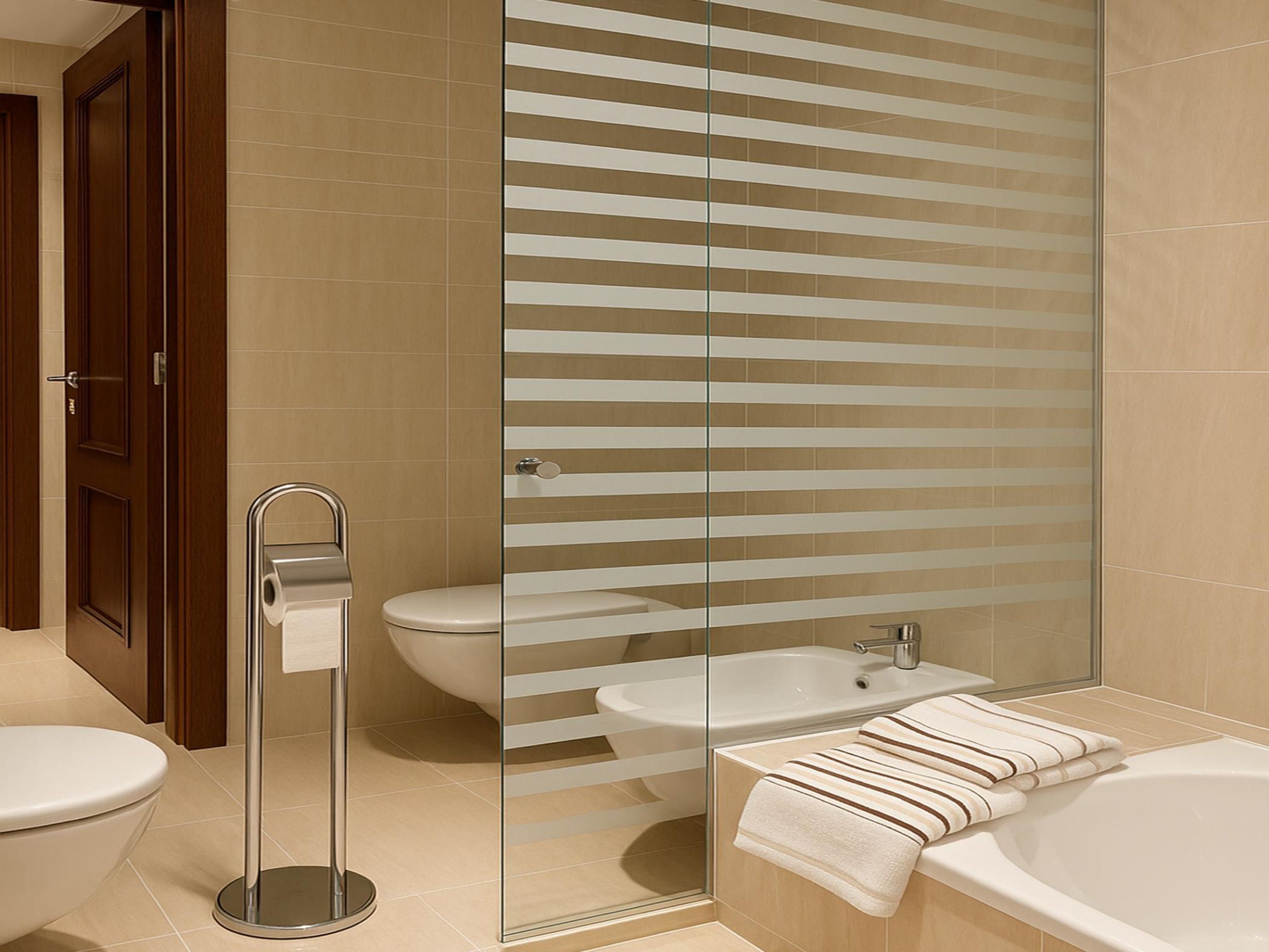 A modern bathroom with a glass shower enclosure, a toilet, a sink, and a bathtub.