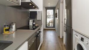 A modern kitchen with stainless steel appliances, a dishwasher, and a built-in oven. - Sitges Spaces Sea View Oasis (Sitges)