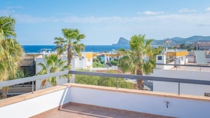 A rooftop terrace with a view of the sea and a mountain in the distance. - Villa Sa Marinada Modern Villa With Pool for 8 People (Sant Josep de sa Talaia)