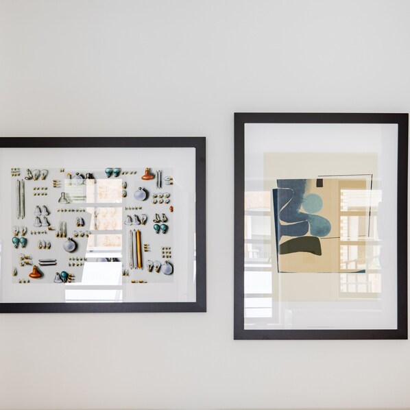 Two framed artworks on a wall.