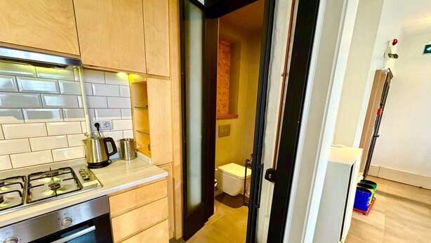 A modern kitchen with a Bosch oven, a gas stove, and a coffee maker on the counter. - Galata Port Flats Chakra 2 (Istanbul)