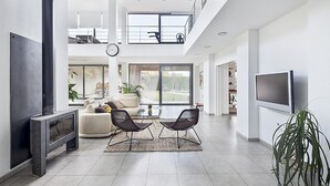 A spacious living room with a fireplace, a large TV, and a balcony. - Garriguella Emporda Costa Brava (Garriguella)