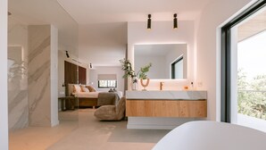 A modern bathroom with a marble vanity, a large mirror, and a view of the outdoors. - Can Palau in Santa Eul ria des Riu (Santa Eulalia del Rio)