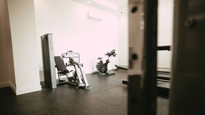 A gym with exercise equipment, a treadmill, and a stationary bike. - 704 (Halifax)