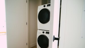 A laundry room with two stacked washing machines. - 704 (Halifax)