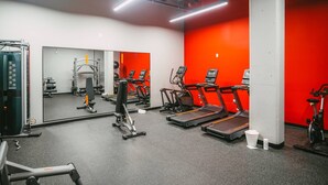 A gym with treadmills, elliptical machines, and weightlifting equipment. - 902 (Halifax)