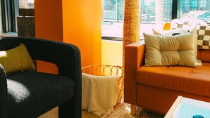 A modern living room with a sofa, a coffee table, and a lamp. - Ph-2e (Halifax)