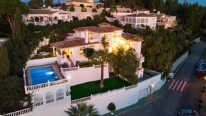 A large, multi-story house with a swimming pool, surrounded by lush greenery and palm trees. - Large Luxury Family Villa 500m From Beach (Mijas)