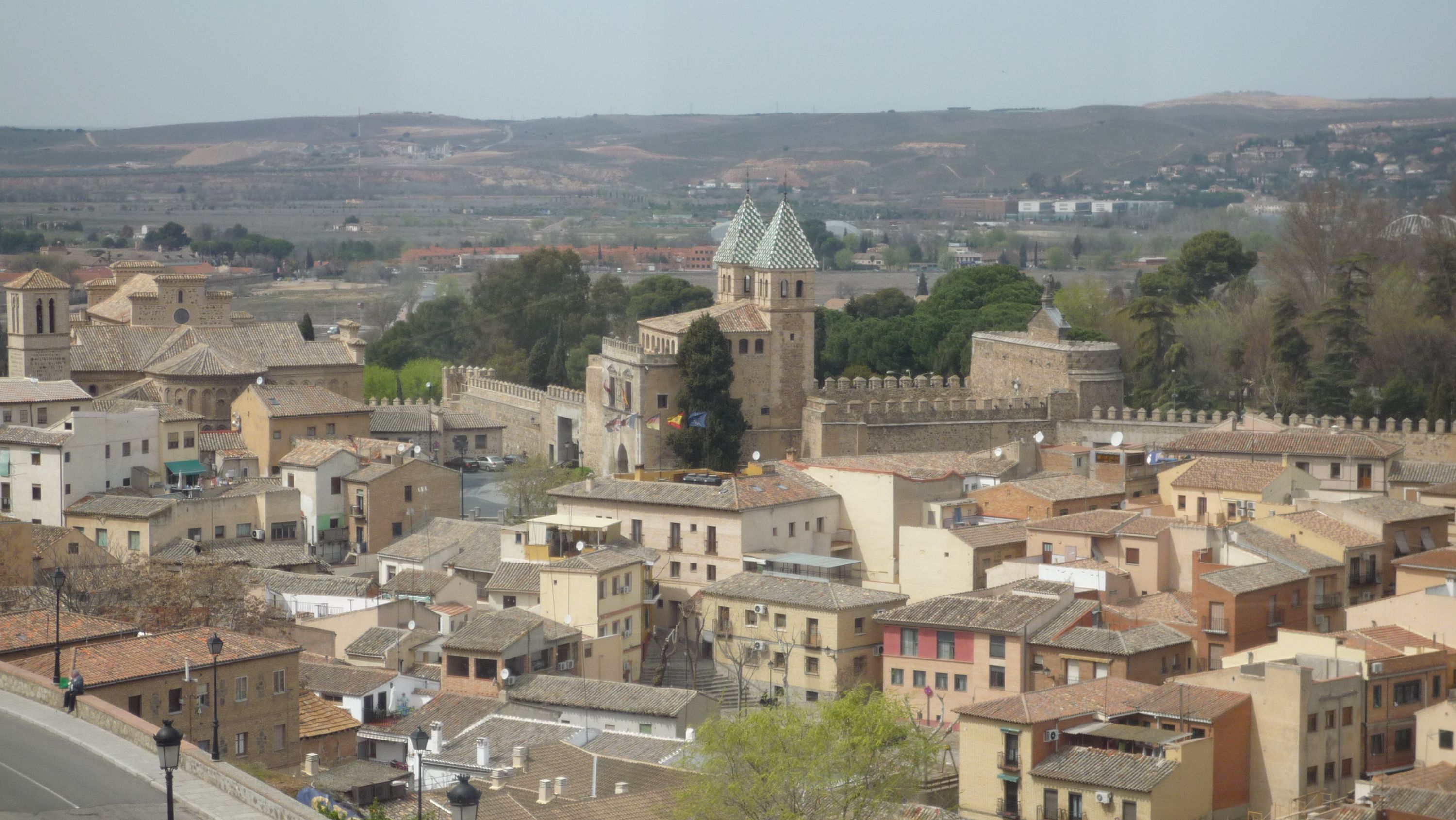 A historic town with traditional architecture, including a prominent tower and a fortified building.